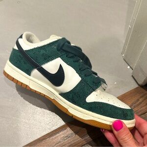 Women's Nike Dunk Low in Pro Green and Black. Unique detailing
